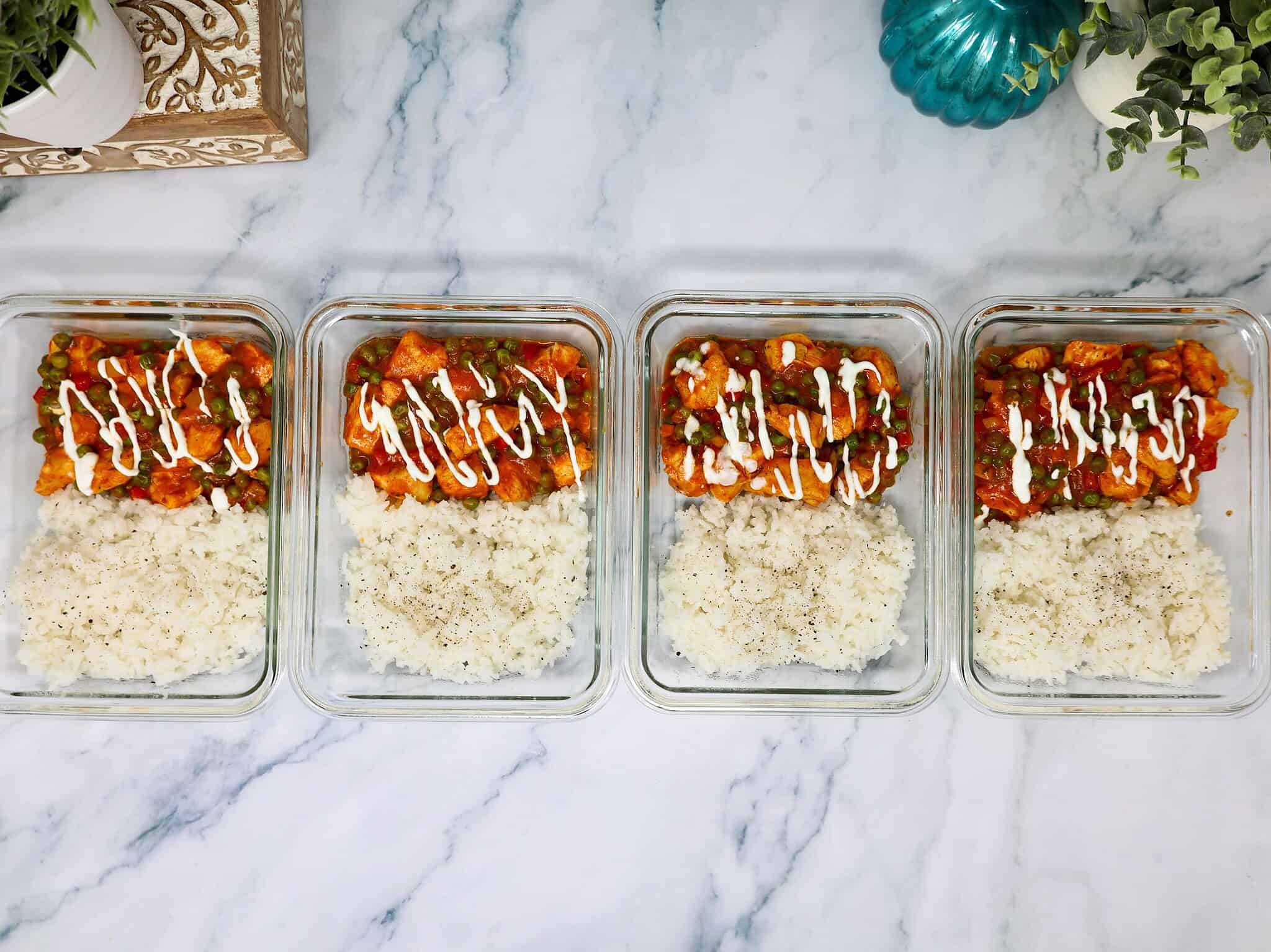 Chicken tikka masala rice bowl made with tender chicken and jarred sauce in meal prep containers