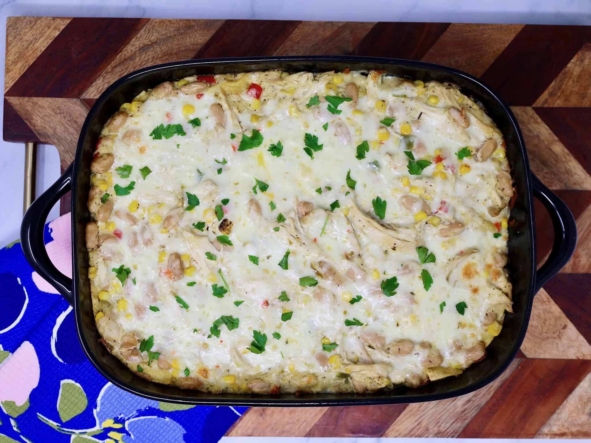 White chicken enchilada casserole baked in a 9×13 inch dish