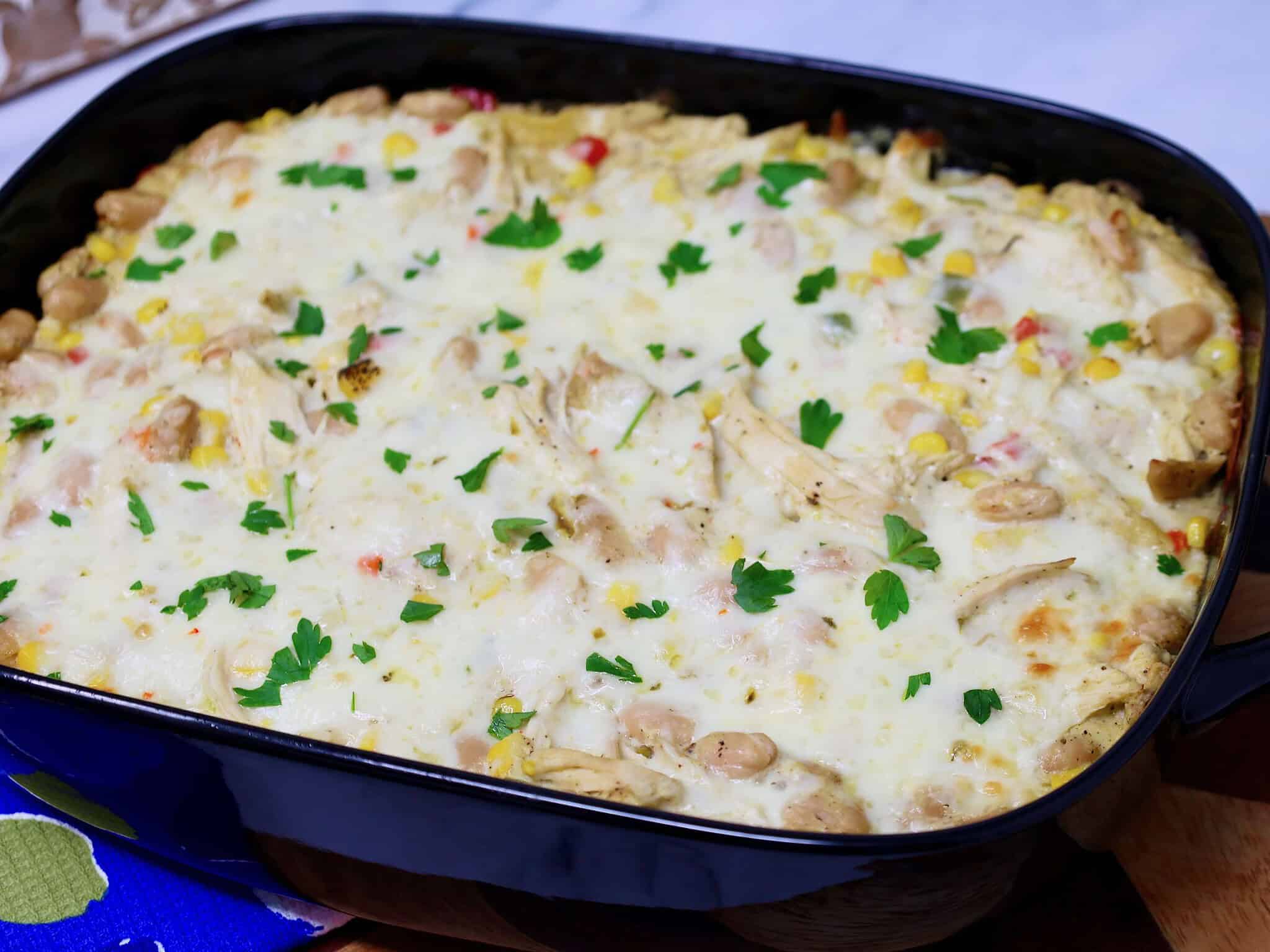Layered chicken enchilada casserole made with corn tortillas and green chile sauce