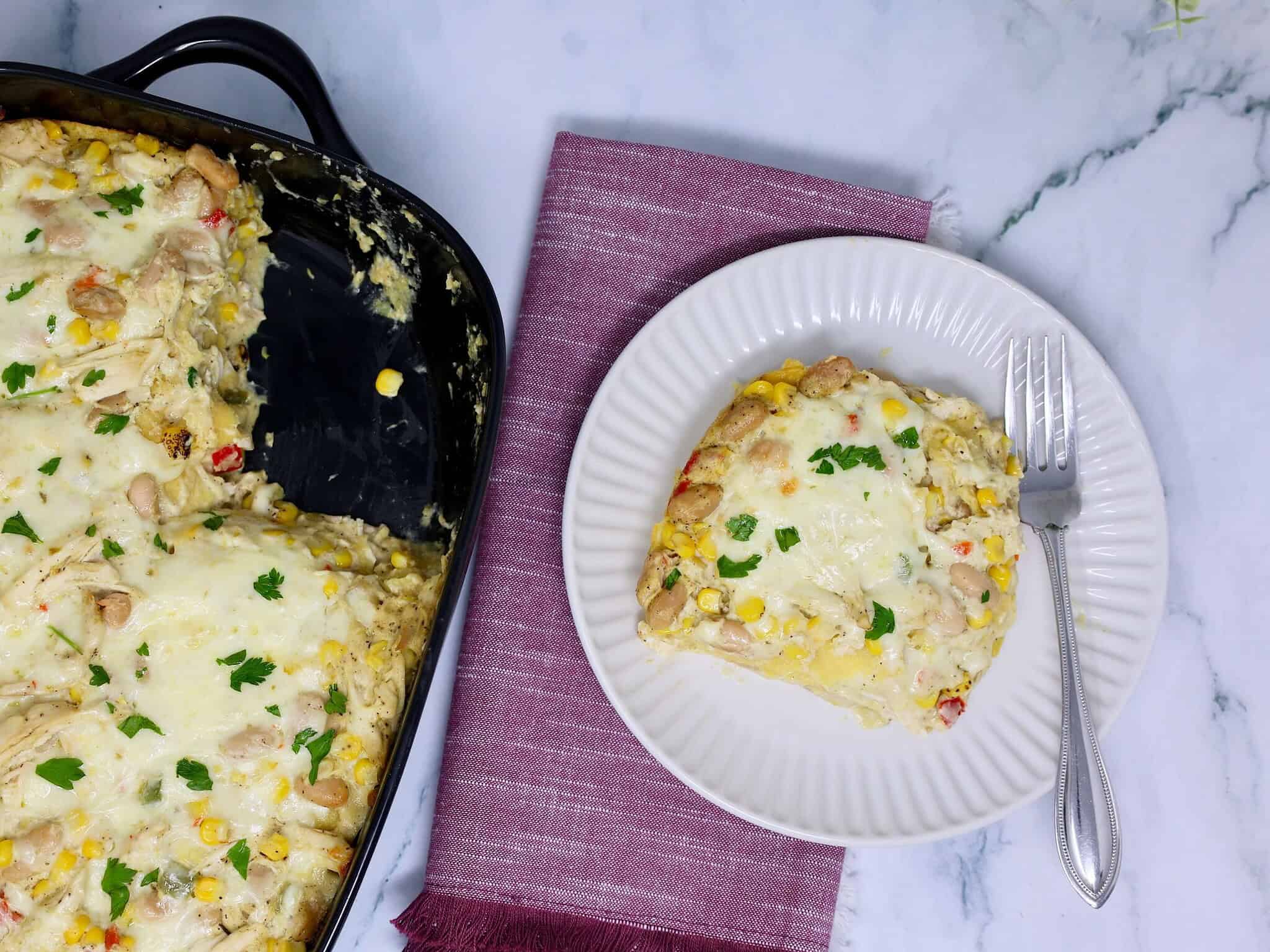 Rotisserie chicken, white beans, corn, and peppers mixed with creamy enchilada sauce