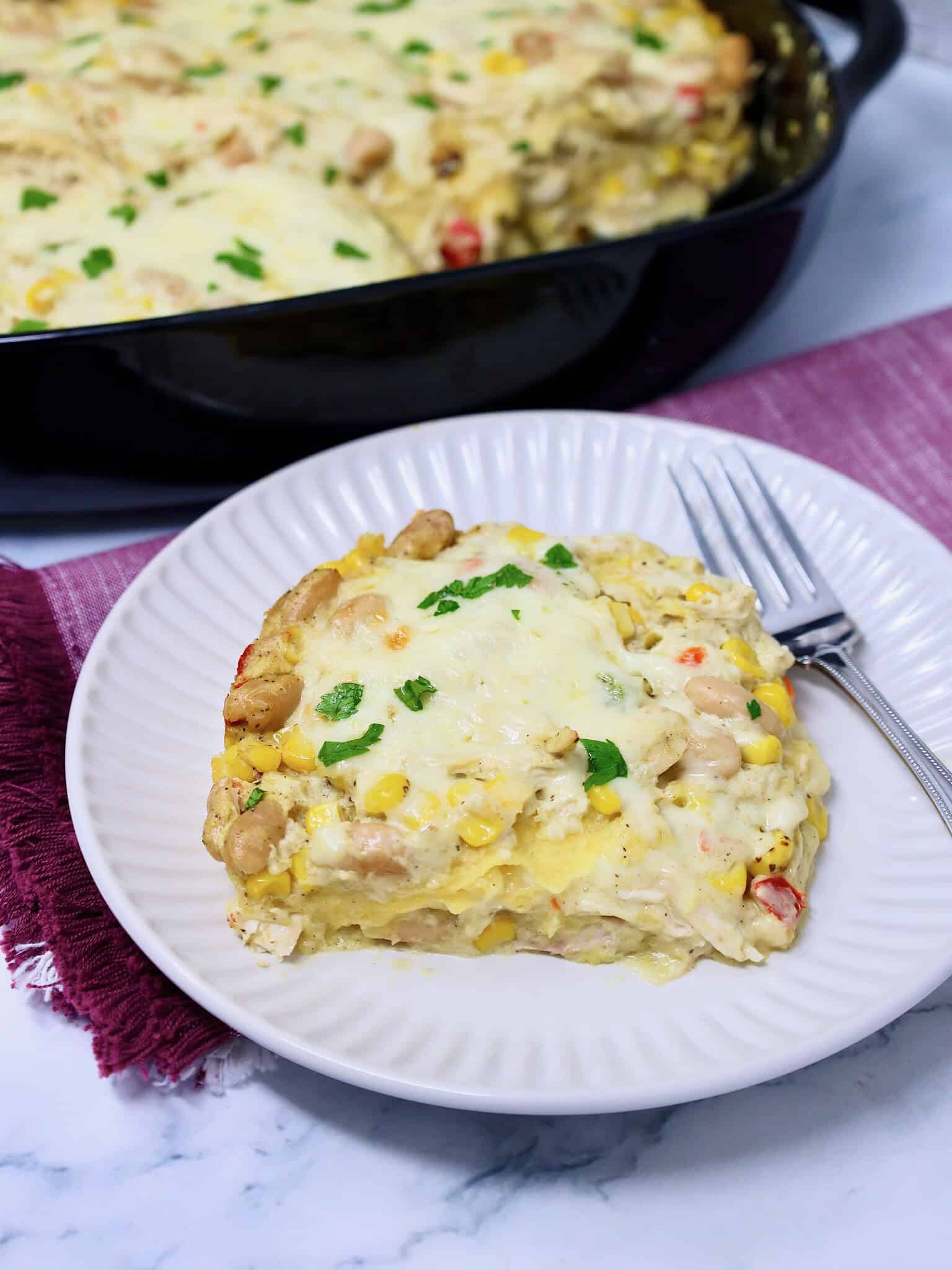 Creamy chicken enchilada casserole garnished with cilantro or you could use sliced jalapeños