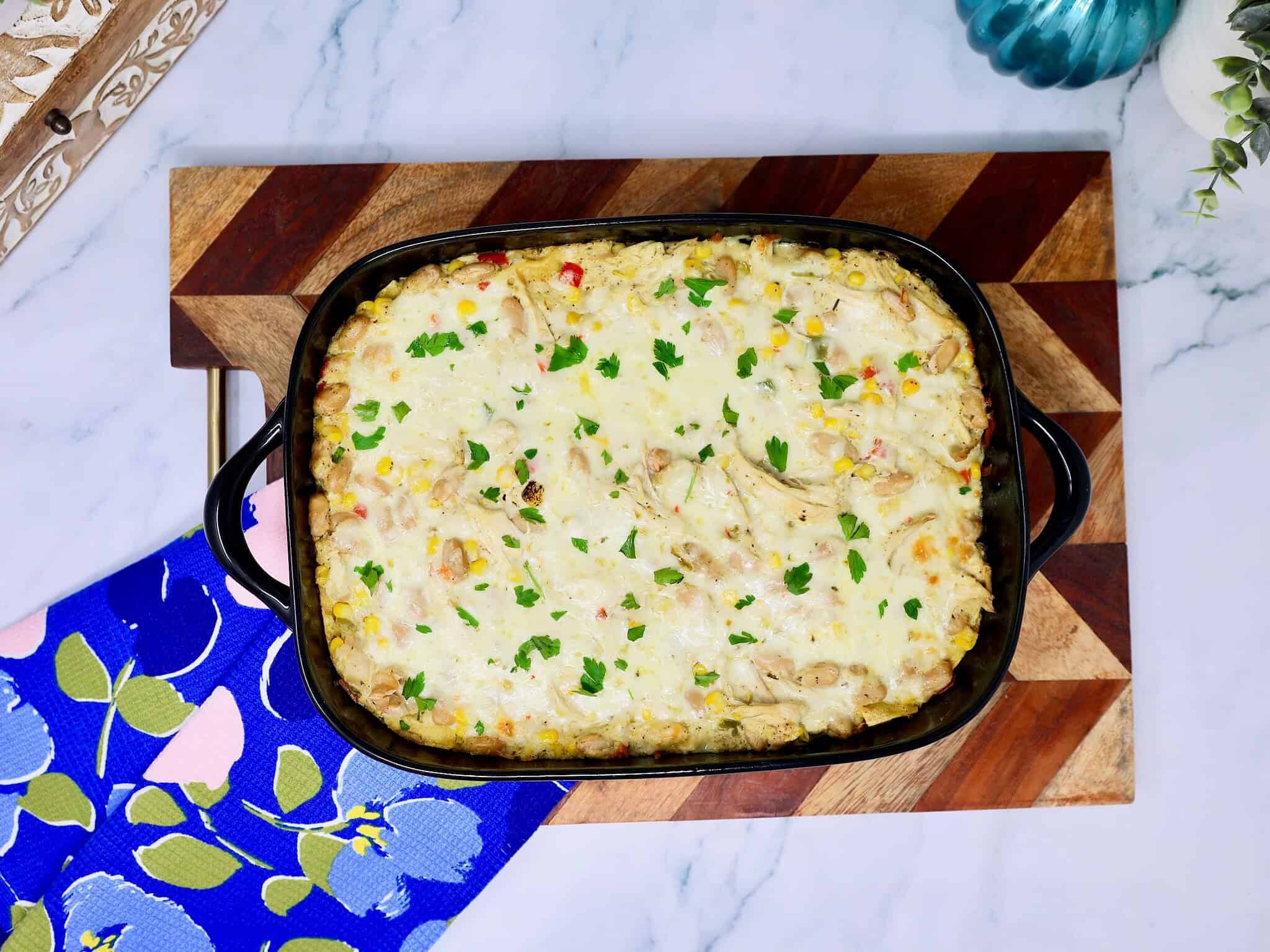 Creamy White Chicken Enchilada Casserole topped with melted pepper jack cheese