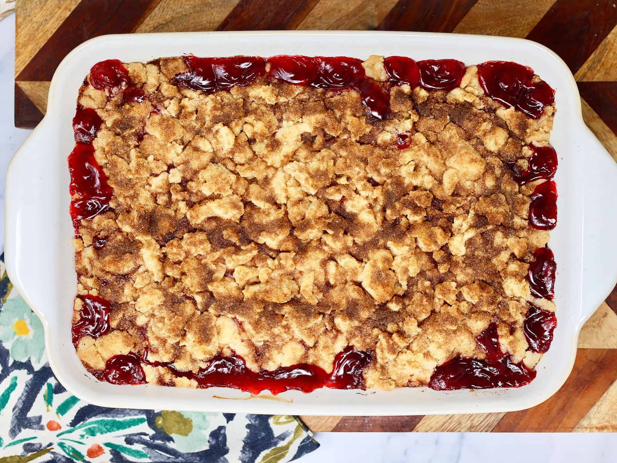 Easy snickerdoodle cherry crisp with golden cinnamon sugar cookie topping over sweet cherry pie filling.