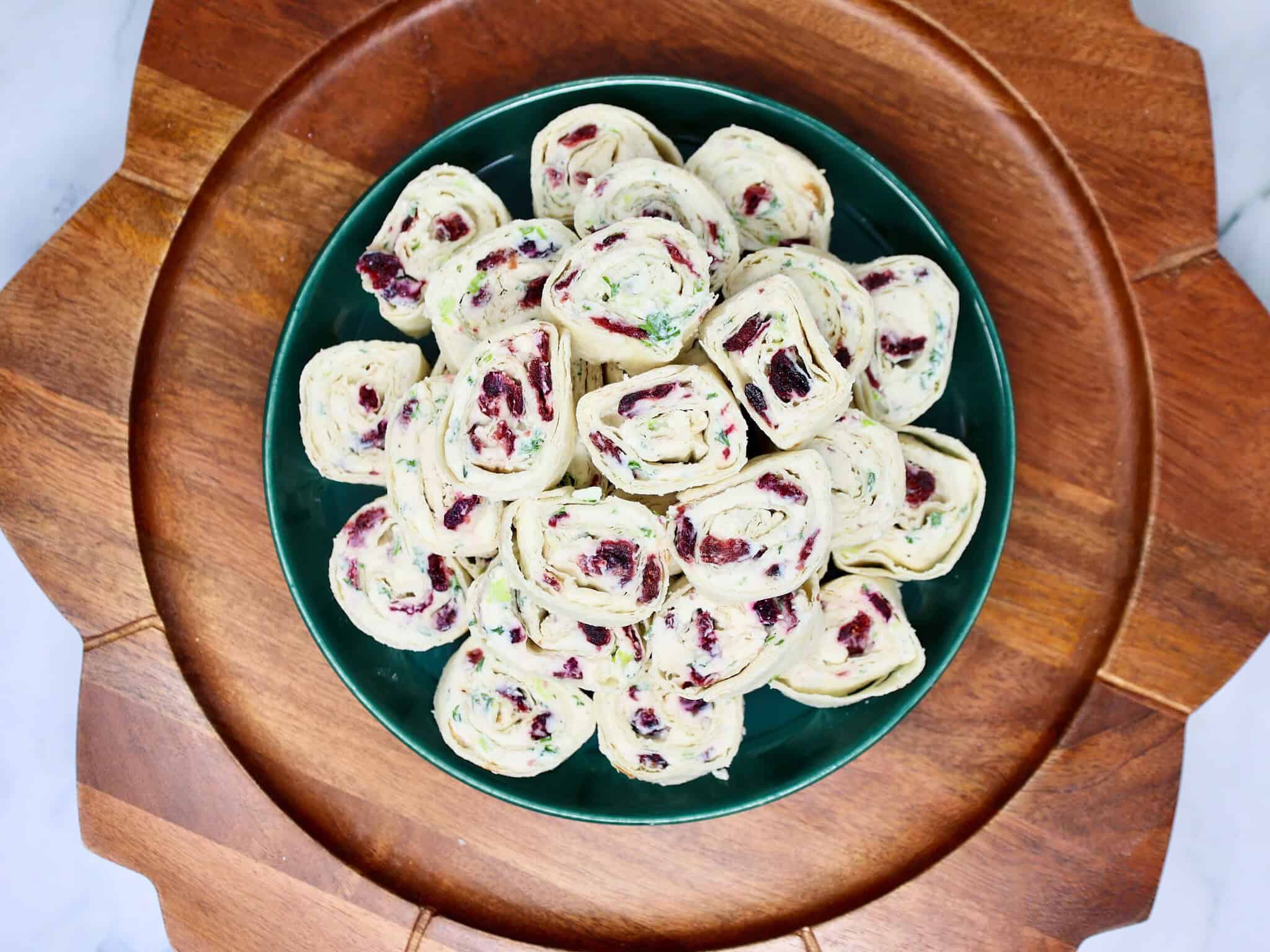 Easy cranberry feta tortilla roll ups arranged on a platter for a holiday party