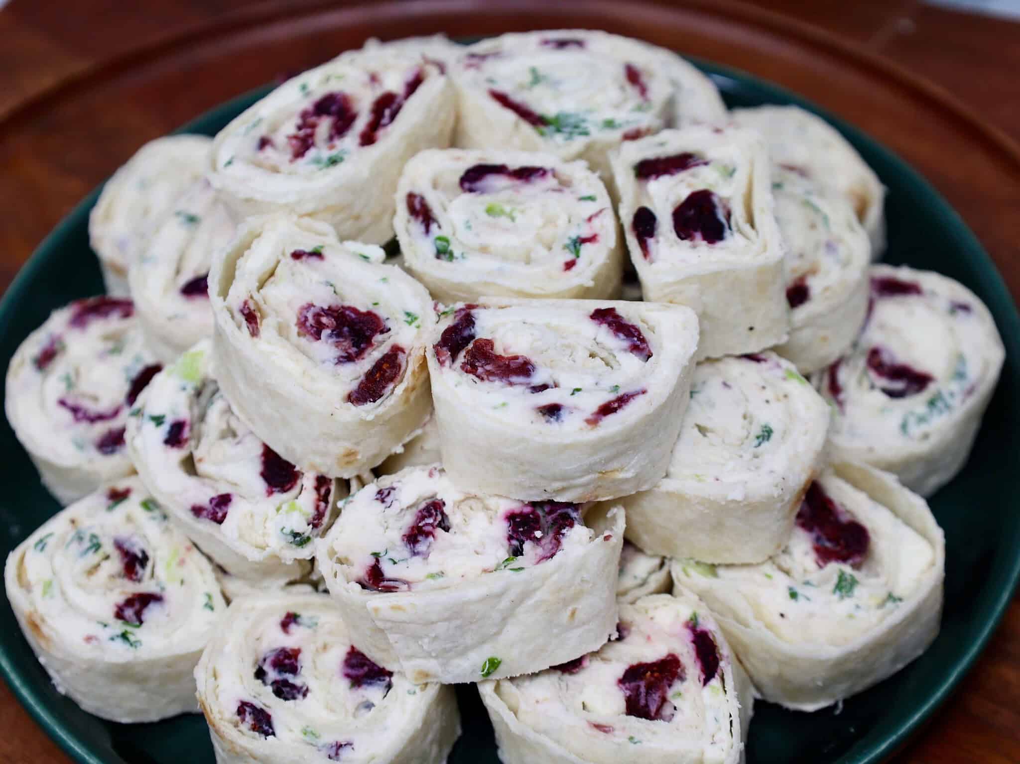 Close-up of cranberry cream cheese pinwheels showing the colorful cranberry and feta filling