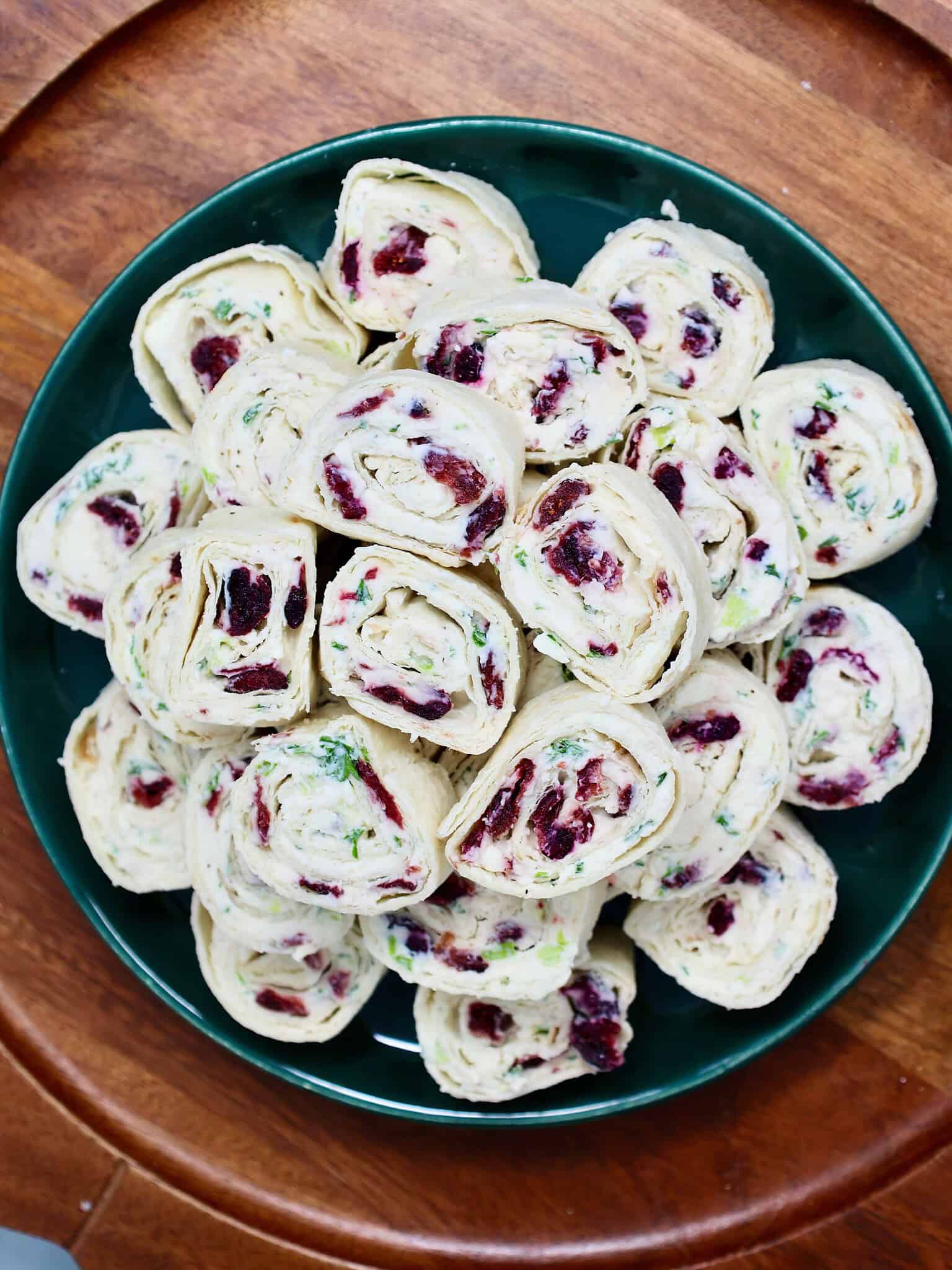 Festive cranberry feta pinwheels served as a make-ahead Christmas party appetizer