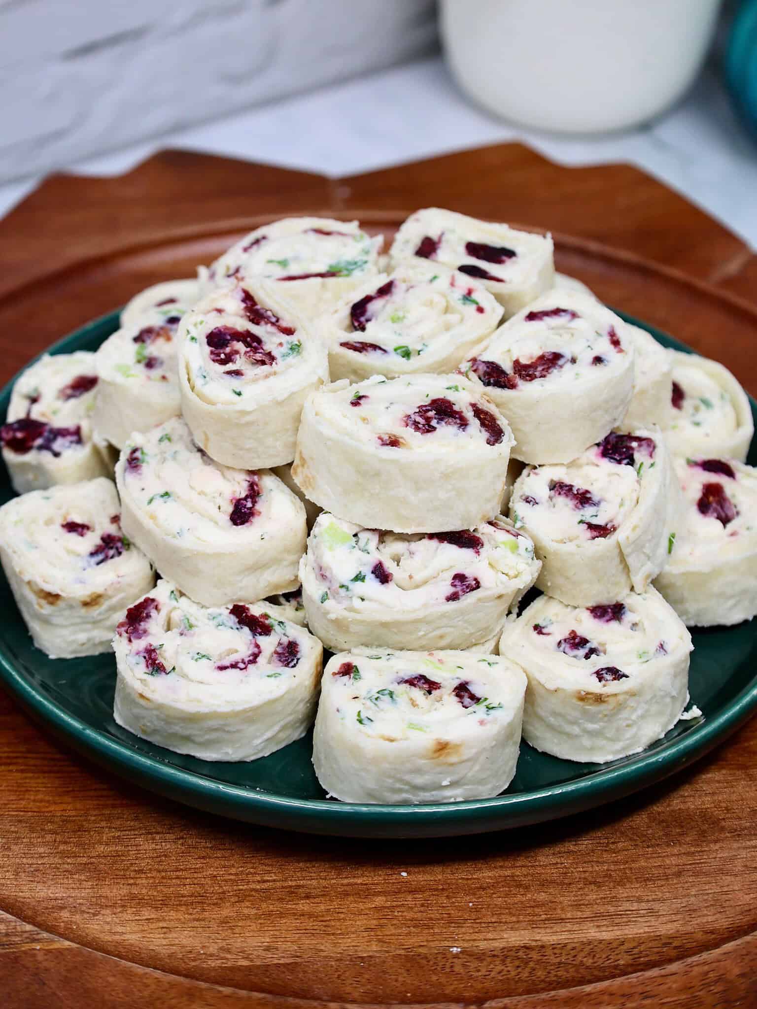 Cranberry feta cream cheese filling spread evenly across a large flour tortilla