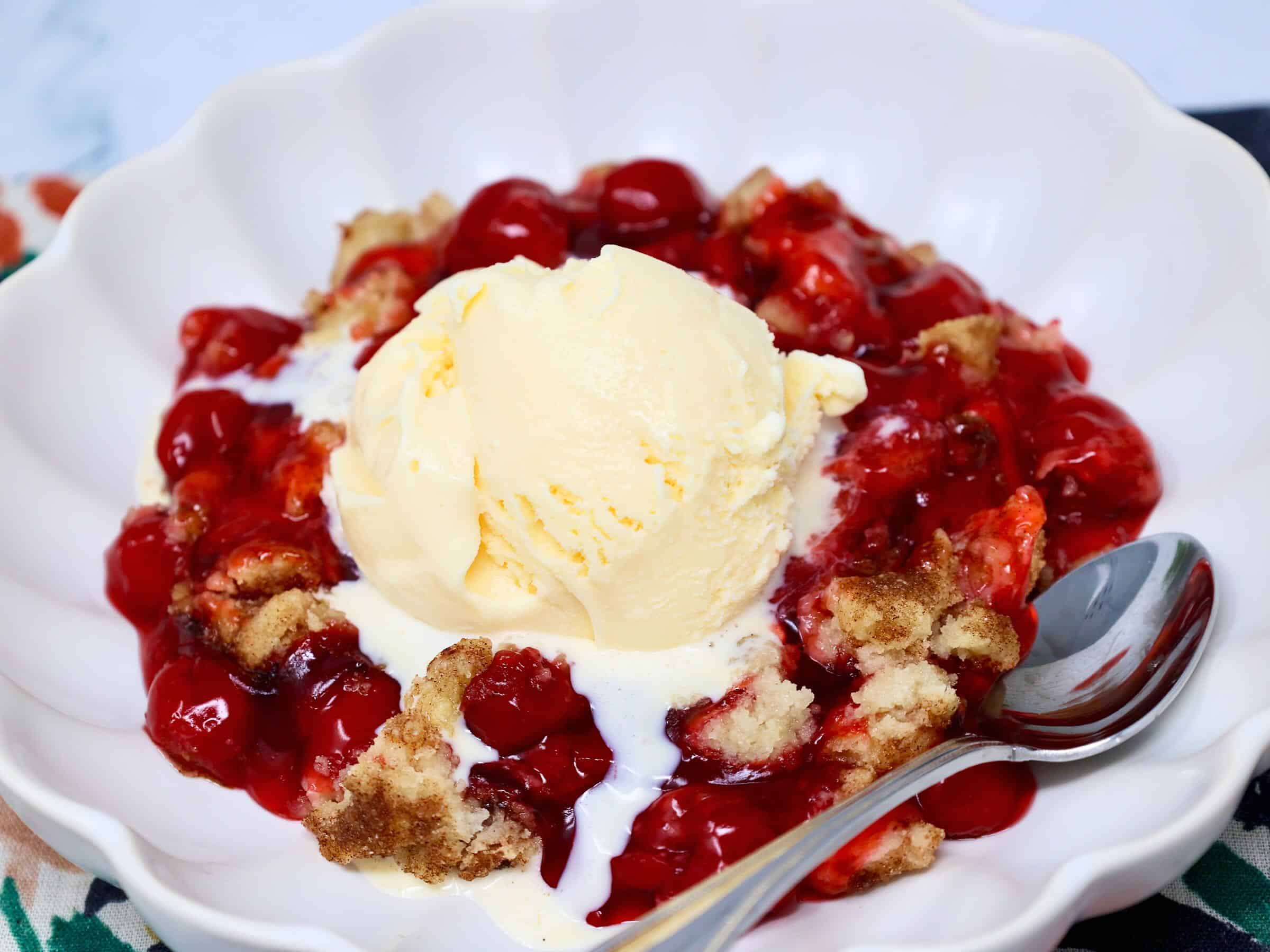 Unbaked cherry crisp with snickerdoodle cookie topping ready for the oven.