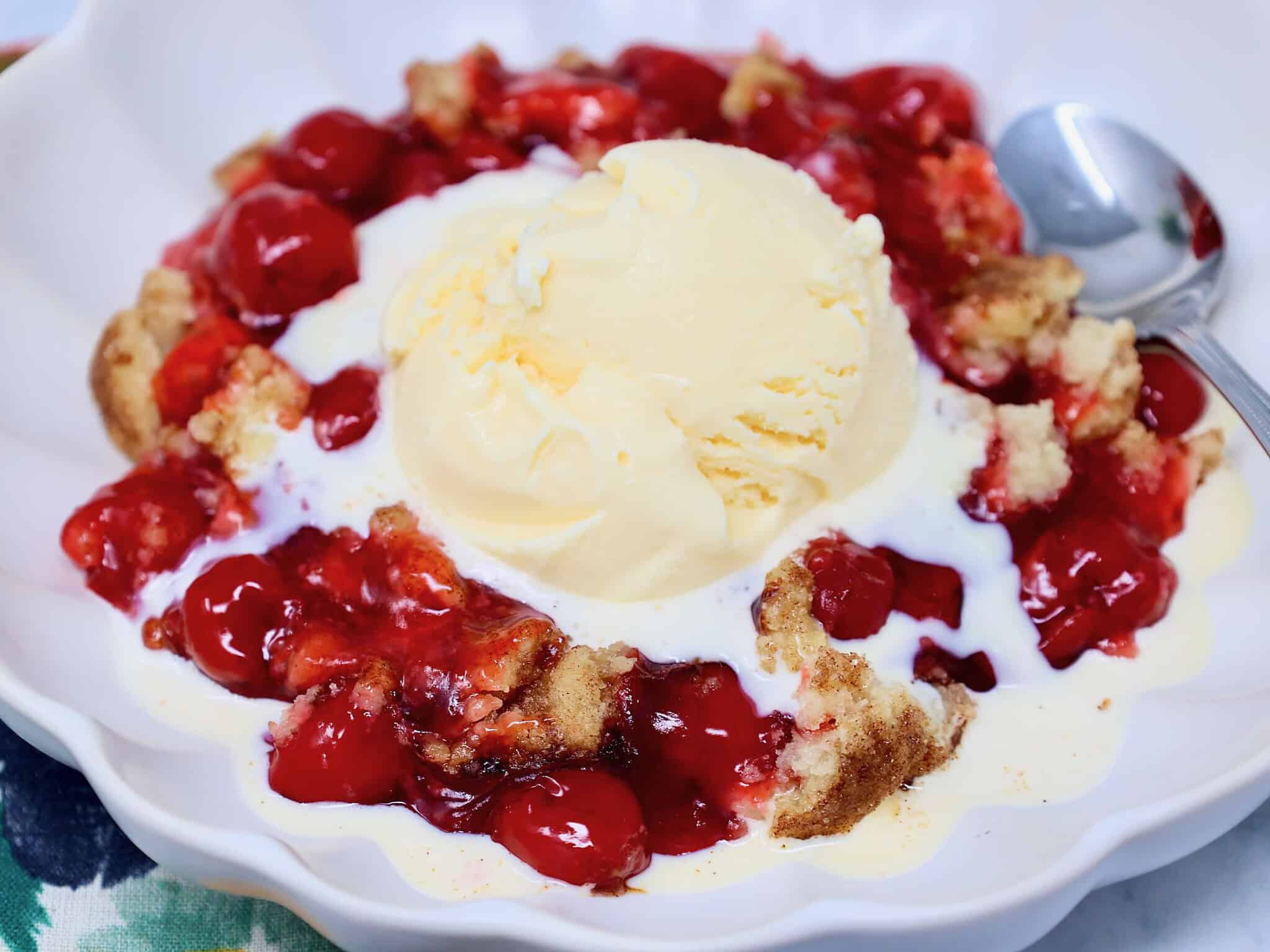 Freshly baked snickerdoodle cherry crisp with golden topping and bubbling cherry filling.